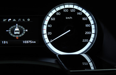 Glossy surface of smartphone on a dashboard inside a car
