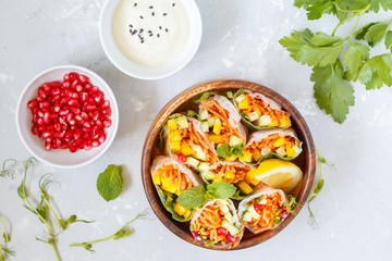 raw spring rolls with vegetables in a wooden bowl