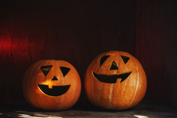 Halloween pumpkins on wooden table on dark background