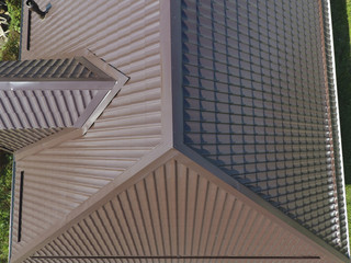 A view from above on the roof of the house. The roof of corrugated sheet. Roofing of metal profile wavy shape