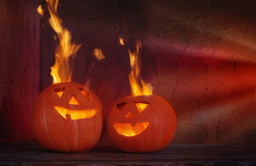 Fototapeta premium Halloween pumpkins on wooden table on dark background