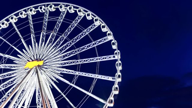 4K resolution time lapse, Close up to part of giant Ferris wheel at night, Fun park background.