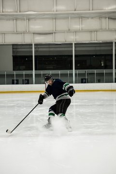 Player playing ice hockey at rink