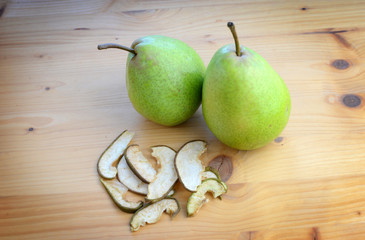 Ripe organic and dried pears on a wooden table, top view.