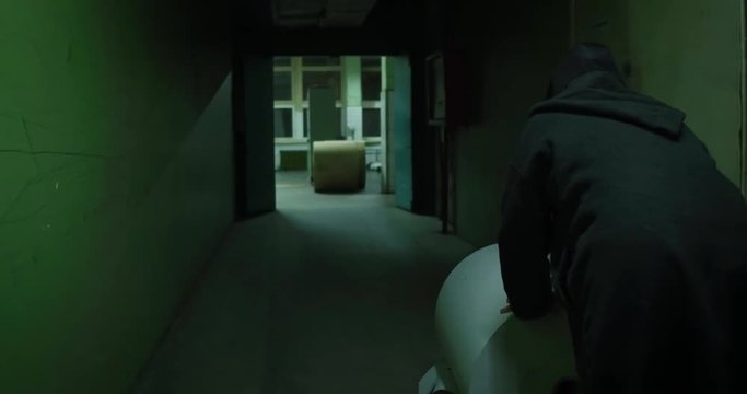 Horror. A man rolls out a large roll of paper