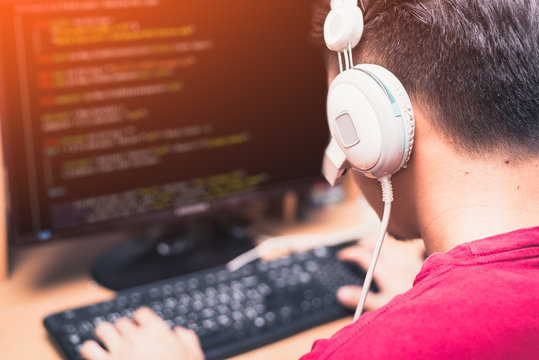 The abstract image of the asian programer developing the software by the desktop computer. The concept of coding, programing, developing, software, education and technology.