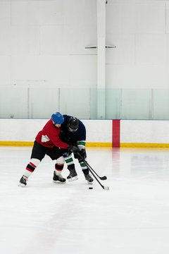 Full length of players playing ice hockey