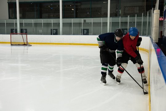 Male players playing ice hockey