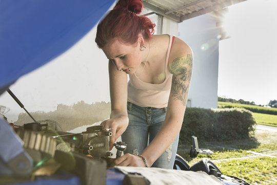 Young woman checking engine
