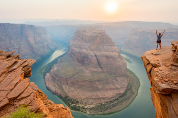 Woman Stands Over the Edge of Horseshoe Bend