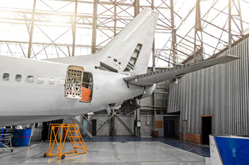 Aircraft in the hangar in the maintenance of plating, interior, tail repair