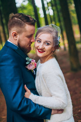  wedding copule. Beautiful bride and groom. Just merried. Close up. Happy bride and groom on their wedding hugging. Groom and Bride in a park. wedding dress.
