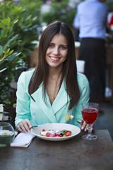 Young beautiful brunette woman бsitting in a restaurant