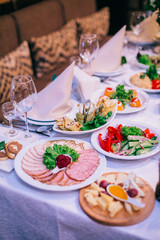 Beautifully decorated tables for guests with decorations and food. 