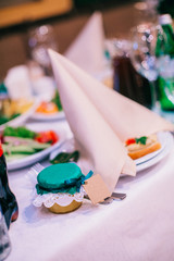 Beautifully decorated tables for guests with decorations and food. 
