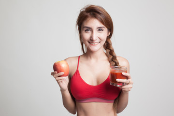 Beautiful healthy Asian girl with tomato juice and apple.