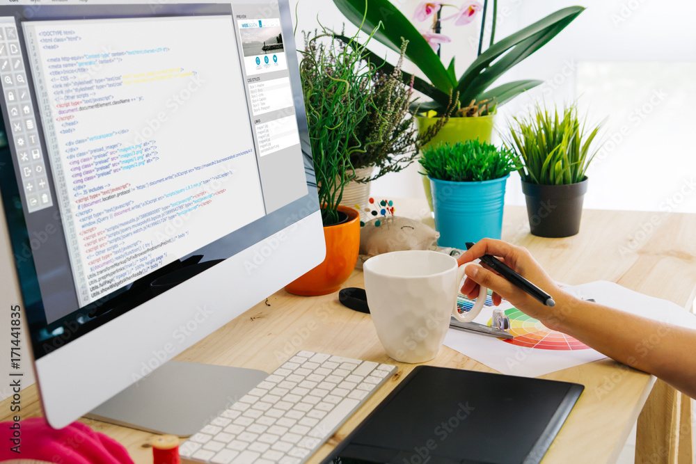 Poster desk with computer and pen tablet website code design