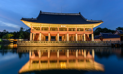 Gyeongbokgung Palace At Night In South Korea, with the name of the palace 'Gyeongbokgung' on a sign