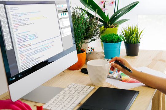 desk with computer and pen tablet website code design