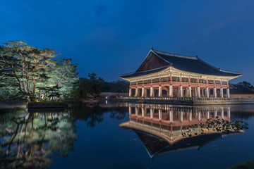 Gyeongbokgung Palace At Night In South Korea, with the name of the palace 'Gyeongbokgung' on a sign