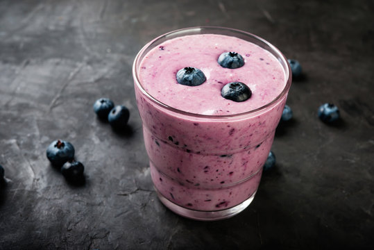 blueberry smoothie with  fresh berries on dark table