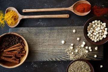 Food frame. A variety of spices in bowls and spoons. Top view, empty space