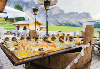 Aperitivo overlooking the Dolomites mountain range in South Tyrol, northern Italy