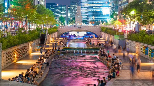 Colorful city lights of Cheonggyecheon Stream Park with Crowd at night in Seoul City, South Korea. 4K Timelapse