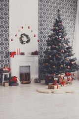Christmas decorated tree in modern interior, holiday concept