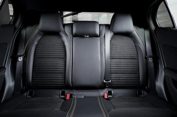 Modern car race interior, black leather with yellow stitch, back seats
