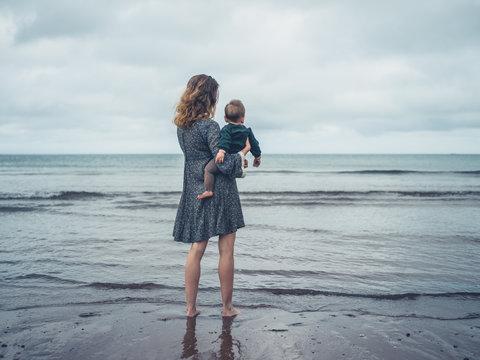 Mother with baby looking at the sea