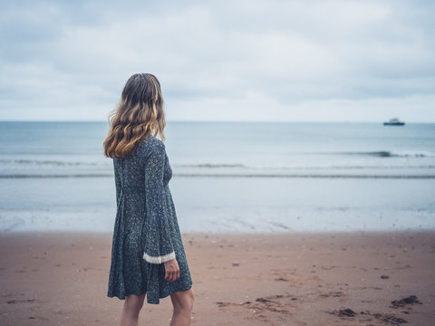Woman in dress admiring the ocean