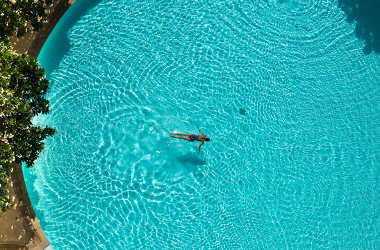 Asian Woman Swimming  In The Pool View From Above