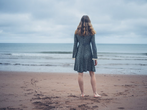 Woman in dress admiring the ocean