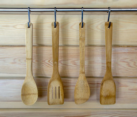 Wooden utensils hanging on wood kitchen wall