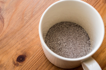 instant coffee powder 3 in 1; mixed with milk powder and sugar in a cup.