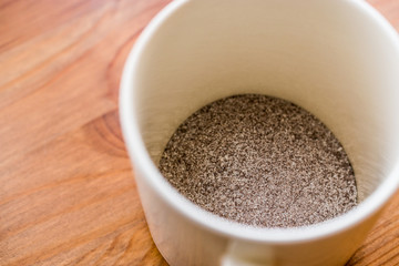 instant coffee powder 3 in 1; mixed with milk powder and sugar in a cup.
