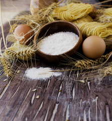 Uncooked pasta with flour on the table, selective focus