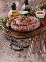 raw beef sausages on a cast-iron pan, selective focus