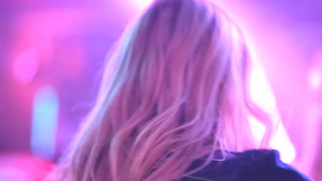 Young guys and girls are dancing in a nightclub at a New Year's party