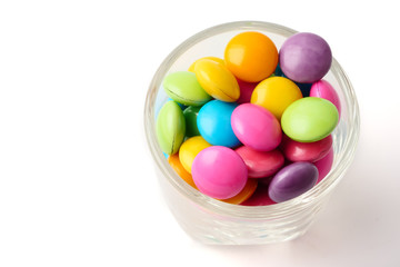 Colorful candies in glass on white background.