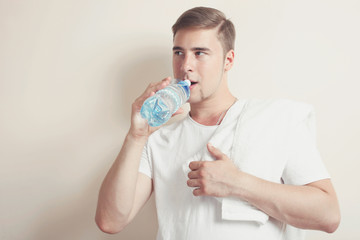 man with a white towel and a bottle of water