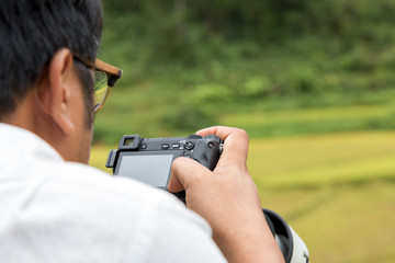 photographer checking photo in camera in his hobby