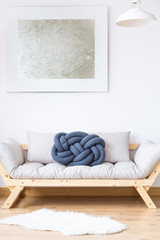 Beige sofa with blue pillow