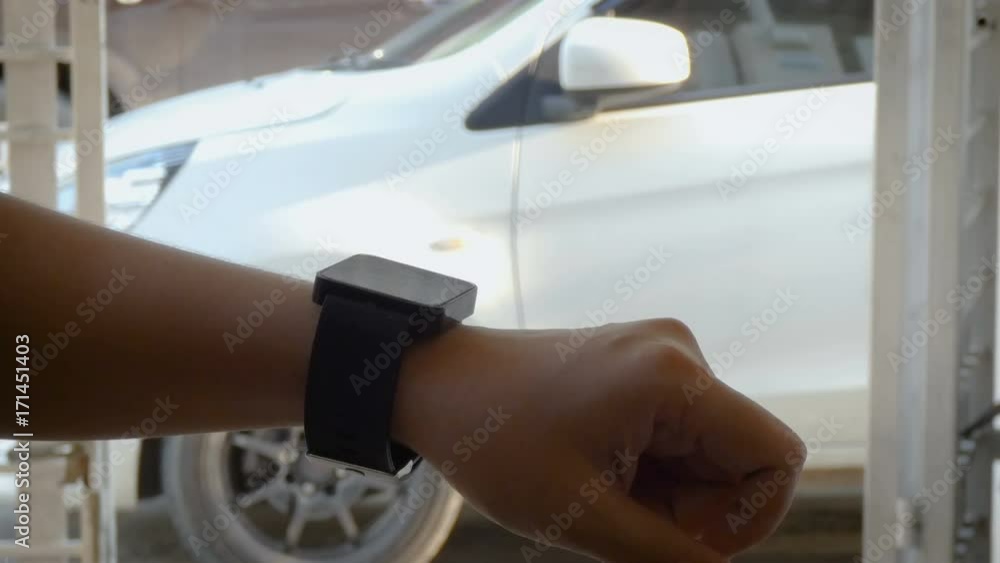 Aufkleber hands of woman using smart watch to open and close lock and unlock the door of car metaphor remote s