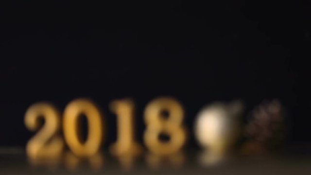 Moving Focus in decoration of golden number 2018 and chistmas ball for Happy New Year and Merry Christmas 2018 background concept