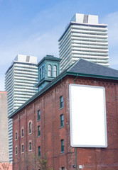 blank billboard old red brick building modern apartment towers