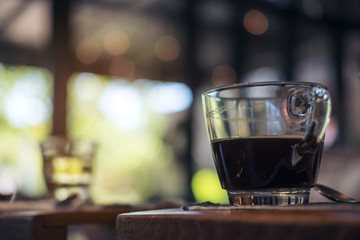 Closeup image of cups of hot coffee and tea on vintage wooden table in cafe with blur bokeh background