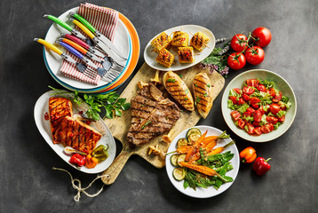 Assorted gourmet meat, foods and dining crockery