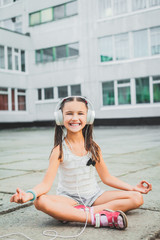 Fototapeta premium nice girl sitting and listening music with headphones